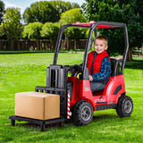 A happy child sitting in a red kids electric forklift loader, lifting a box outdoors.